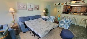 a living room with a blue couch and a table and chairs at Saida Royale 9018 condo in South Padre Island +95 photos