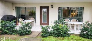 a patio with tables and chairs in front of a house at Saida Towers IV #108 condo in South Padre Island