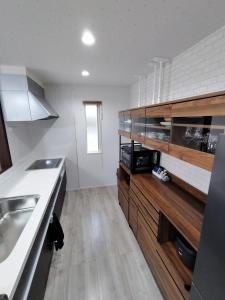 a kitchen with a sink and a counter top at Seaside House Cozy - Vacation STAY 03320v in Sammu