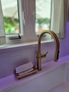 a bathroom sink with a faucet and some towels at Salt&Sage - Modern 3BR Fully Renovated in May 2025 in Pembroke +48 photos