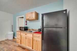 a kitchen with a stainless steel refrigerator and wooden cabinets at ATV Trails and River Access Briceville Retreat in Briceville