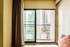 a large window with a view of a city at Noble Remix Bangkok in Bangkok