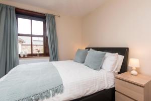 a bedroom with a large bed with a window at Stanley Lodge Farmhouse in Cockerham