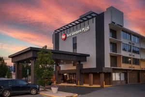 a building with a car parked in a parking lot at Best Western Plus Laurel in Laurel