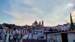 a group of buildings on a hill with a city at Casa del Patrón Posada in Taxco de Alarcón