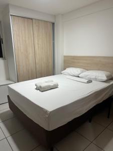 a bed with two towels on it in a room at Apartamento West Flat AP213 in Mossoró