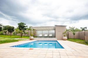 a swimming pool in the backyard of a house at Secret Oasis in Lusaka