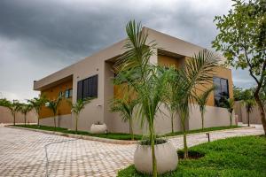 a building with palm trees in front of it at Secret Oasis in Lusaka