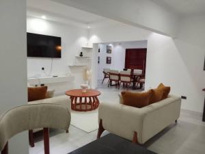 a living room with a couch and a table at Secret Oasis in Lusaka