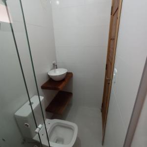 a bathroom with a toilet and a sink at Lofts mahalo in Ubatuba