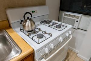 a tea kettle sitting on top of a stove at Hells Kitchen Hideaway in New York