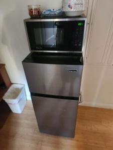 a microwave oven sitting on top of a refrigerator at Hollywood Hills Hideout Apartment! in Los Angeles +11 photos