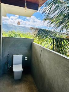 a bathroom with a toilet with a large window at Blue Mountains View in Dambulla +86 photos