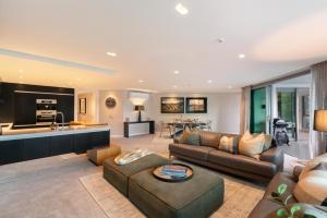 a living room with a couch and a table at Q1 Luxury Central Apartment in Queenstown +21 photos