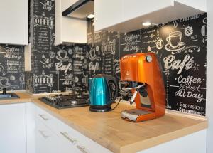 a kitchen with an orange mixer on a counter at Apartament Kabaty in Warsaw
