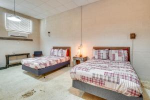 a bedroom with two beds and a table with a lamp at The Boiler Room - ATV-Friendly Briceville Gem! in Briceville +19 photos