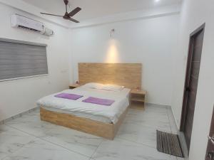 a bedroom with a bed with purple towels on it at Oceanic Holidays Lakshadweep in Agatti