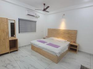 a bedroom with a bed and a ceiling fan at Oceanic Holidays Lakshadweep in Agatti
