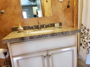 a bathroom with a sink and a mirror at The God Spa in Redding
