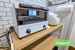 a toaster oven sitting on a counter in a kitchen at Vacation House 1 in Funabashi +131 photos