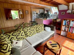 a living room with a couch and a table at Maison calme au hameau pour 6 à Lans-en-Vercors - FR-1-761-48 in Lans-en-Vercors