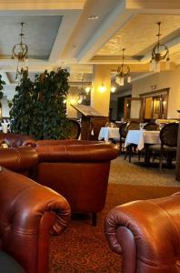 a restaurant with brown leather chairs and tables and tablesearcher at Havasi View Donovaly - 2 Bedrooms, Mountain View, Garage, 2 WC, Balcony, Dishwasher, Guitar, 164 cm TV, Netflix in Donovaly