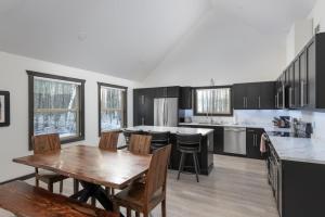 a kitchen with a wooden table and a dining room at The Sundance Cabin in Valemount