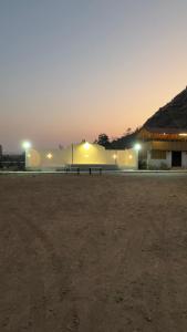 an empty parking lot with a bench at night at Holiday Home Agro Tourism 