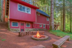 a fire pit in front of a red building at Rainier Vintage Retreat With Hot Tub-Fireplace-WiFi in Ashford