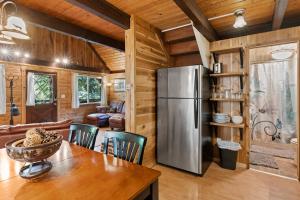 a kitchen and dining room with a stainless steel refrigerator at Rainier Vintage Retreat With Hot Tub-Fireplace-WiFi in Ashford