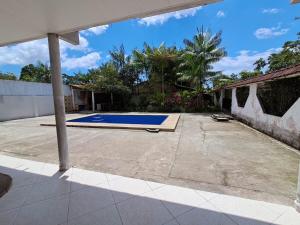 an empty courtyard with a swimming pool in a house at Casa Ariramba - Your place in COP30 in Belém