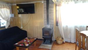a living room with a wood stove in it at casa completa Balmaceda 77 in Concepción