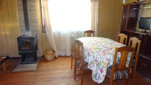 a dining room with a table and a stove at casa completa Balmaceda 77 in Concepción