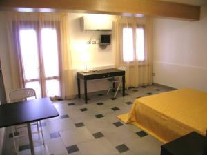 ヴェネツィアにあるB&B Casa in Lagunaのベッドとデスクが備わる客室です。