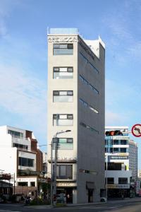 a tall building on a city street with buildings at The Moor in Busan