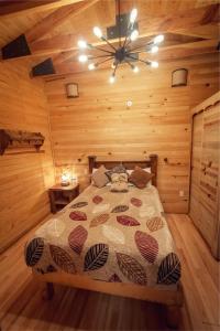 a bedroom with a bed in a wooden room at Roca Venados in Mascota +2 photos