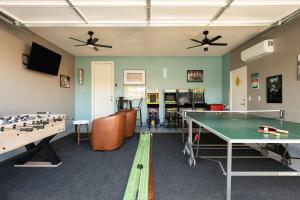 a gaming room with a ping pong table and counters at NEW Sunset Palms, AC Gameroom, Pool, Spa, EV charger in Indio