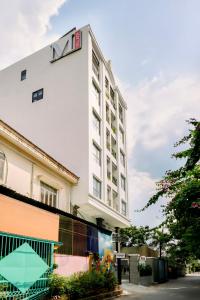 a white building with a sign on top of it at Express by M Village 46 Thảo Điền in Ho Chi Minh City