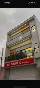 a building with a sign on the front of it at Pousada Capivara Express in Baixas +5 photos