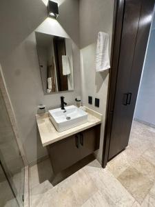 a bathroom with a sink and a mirror at Studio with balcony in the downtown, WiFi 150MB, laundry and parking free in Tulum