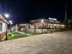 a building with lights in front of it at night at Casa di Nobilis in Gheboieni
