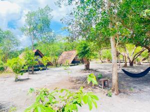 a hammock in the middle of a yard with trees at Veha Koh Rong in Kaôh Rŭng