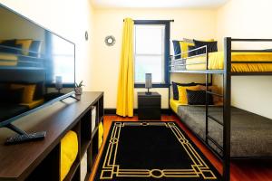 a room with two bunk beds and a desk at The Amber Retreat Private Rooms with Shared Kitchen, Living Room And Bathroom Free Street Parking Near Downtown in Cleveland
