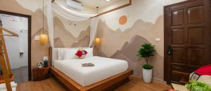 a bedroom with a white bed in a room at Wanderlust Staycation in Hanoi