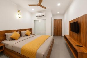 a bedroom with a bed and a television in it at hotel-montreal rishikesh madhuban inn in Rishīkesh