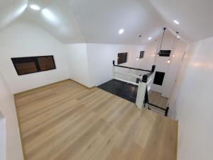an empty room with white walls and wooden floors at D'Ryan Tiny House with Private Pool in Jeniang