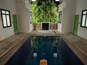 a pool of water in the middle of a building at D'Ryan Tiny House with Private Pool in Jeniang