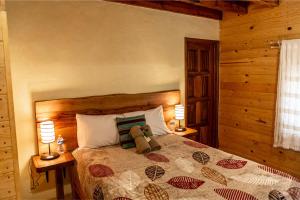 a teddy bear sitting on a bed in a bedroom at Roca Venados in Mascota