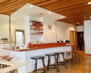 a bar in a restaurant with bar stools at Private Fireworks View & Hot spring Villa Atami in Atami