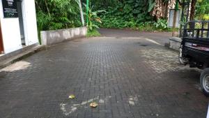 a brick walkway with a street at Secret forest waterfall retreat in Petang